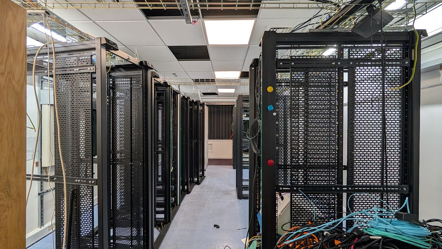 Rows of black equipment racks in the legacy equipment room.