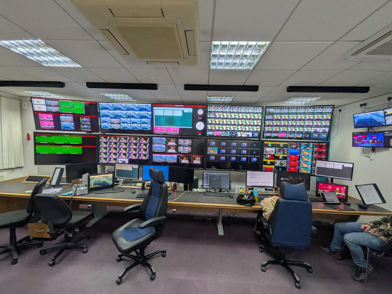 The Comux UK master control room: a wall of multiviewer screens above the operators' desk.