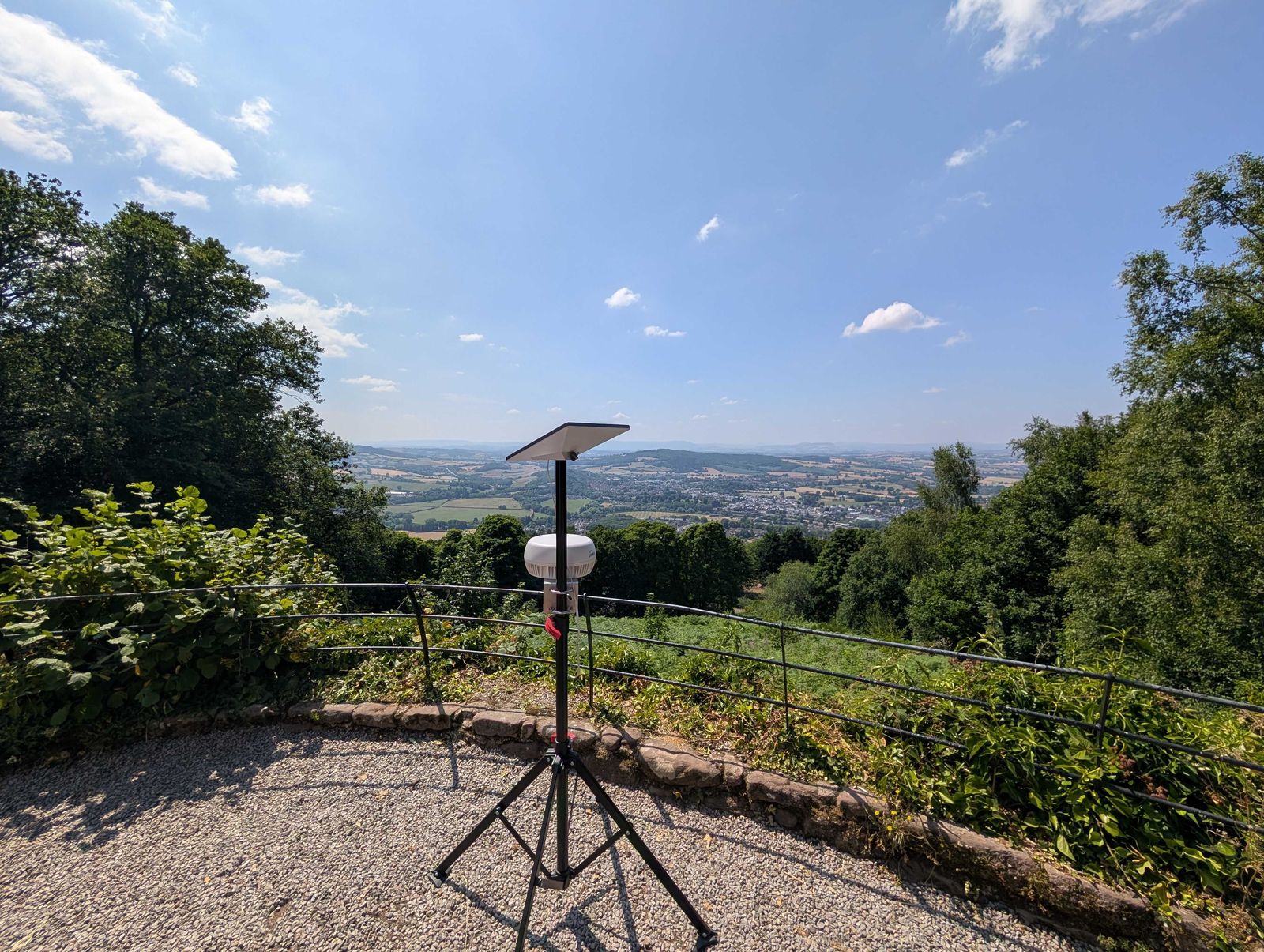A Starlink dish and Peplink BR1 bonded antenna on a tripod, overlooking the Wye Valley.